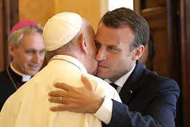 Pope Francis and Emmanuel Macron embrace each other cheek to cheek